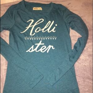 A green long sleeve Hollister shirt